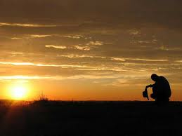 prayer in field w sunset